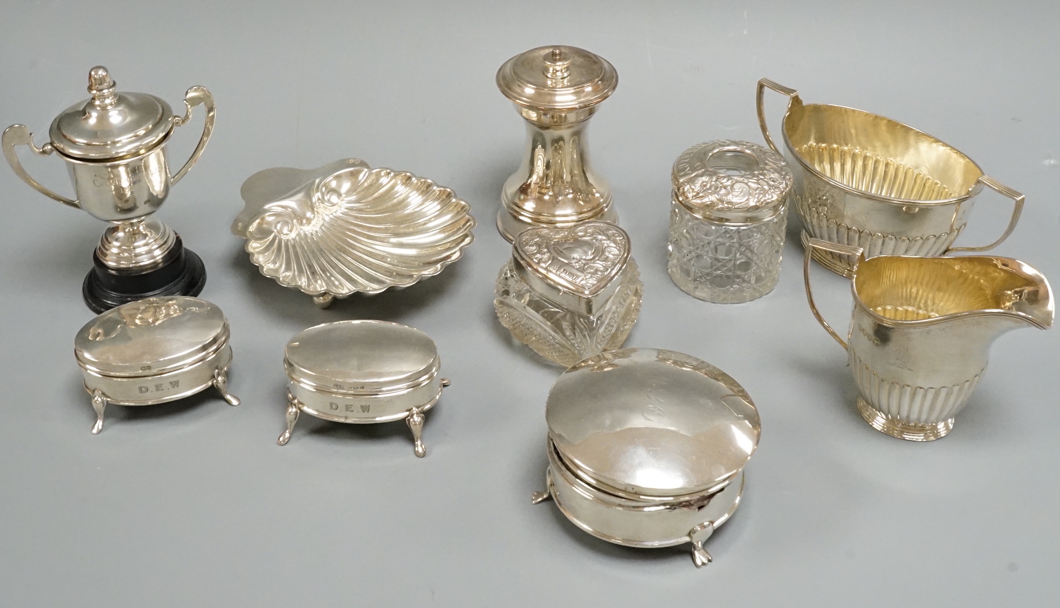 Sundry silver including cream and sugar, trinket boxes, butter shell, toilet jars, etc.